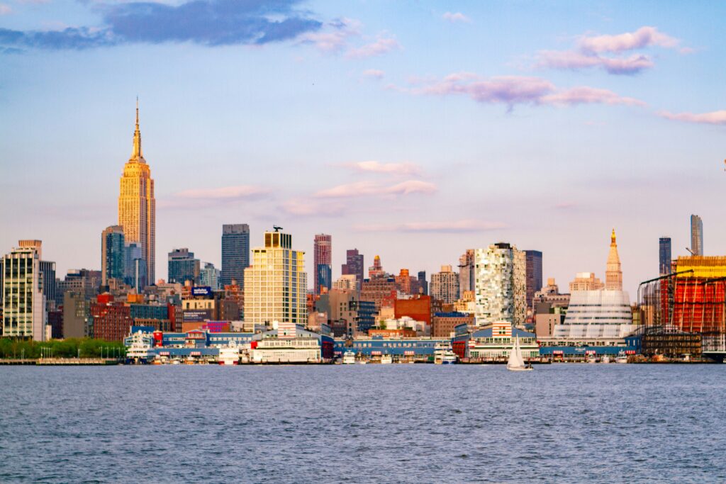 New Jersey city skyline during the day with the water in the foreground.