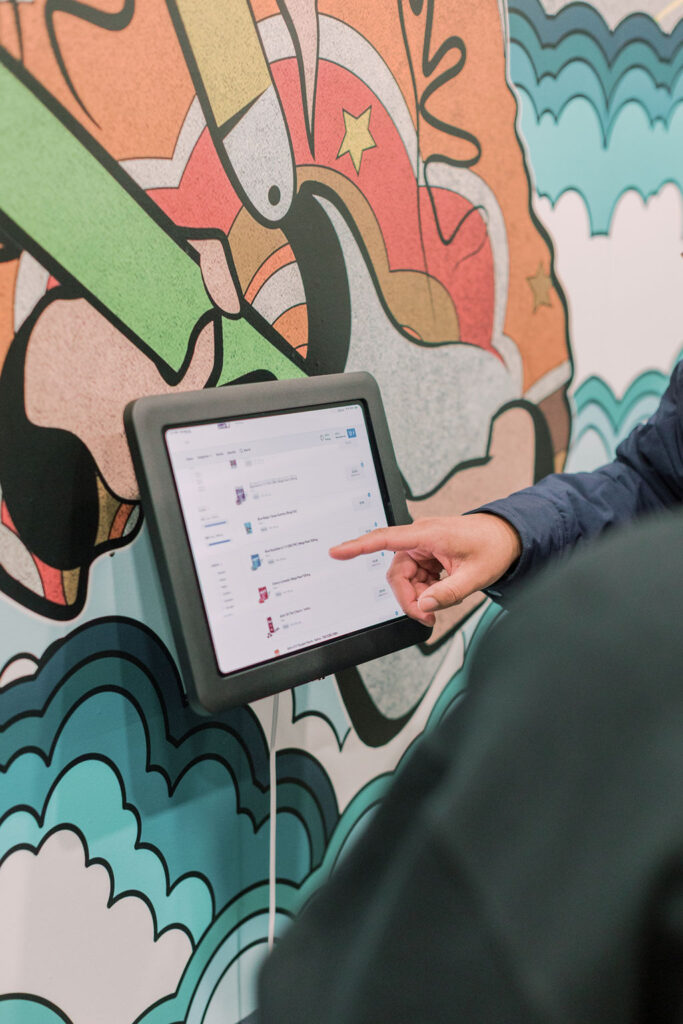 A La Vida Gardens budtender helping a customer make a selection on a tablet to buy cannabis.