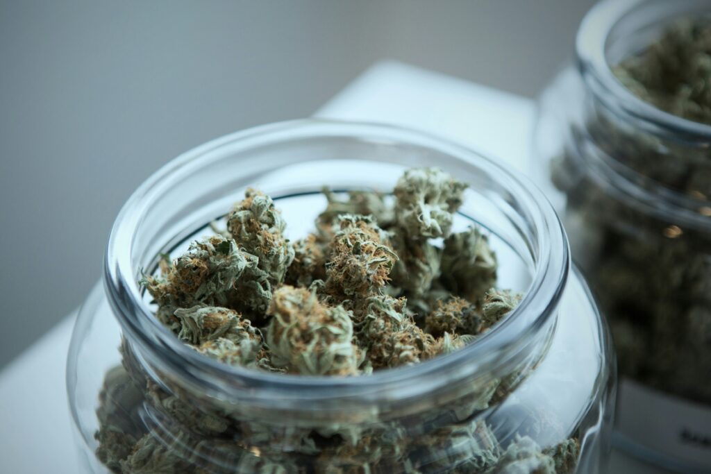 Open jar of cannabis flower.